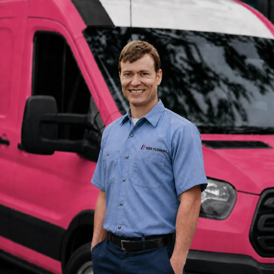 Rivo Plumbing plumber in front of the van